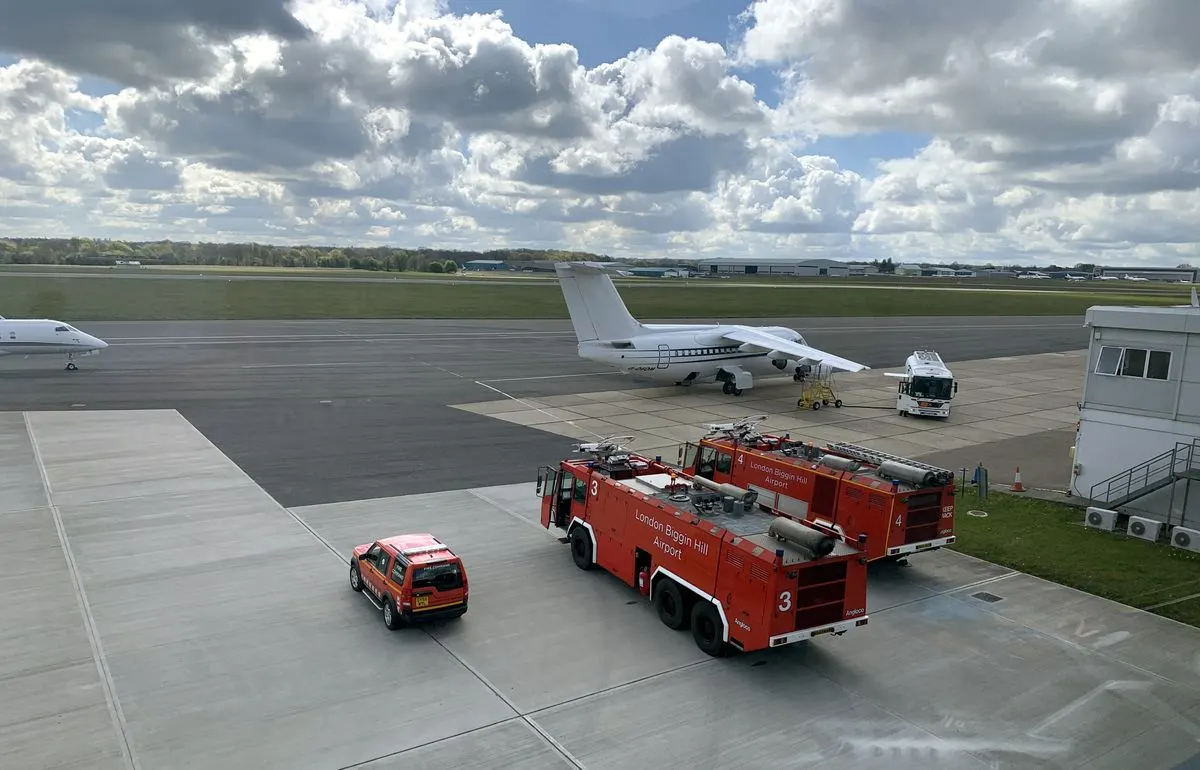 The apron at a private jet airport with aircraft and fire vehicles