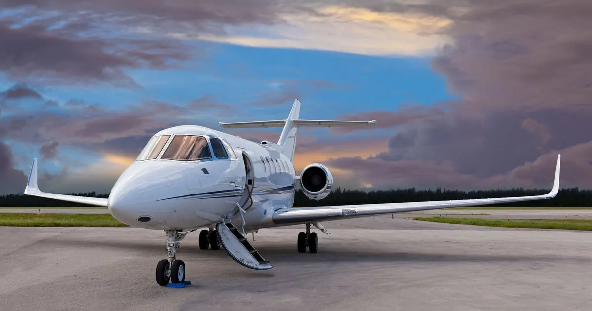 A private jet at dusk with its airstair down
